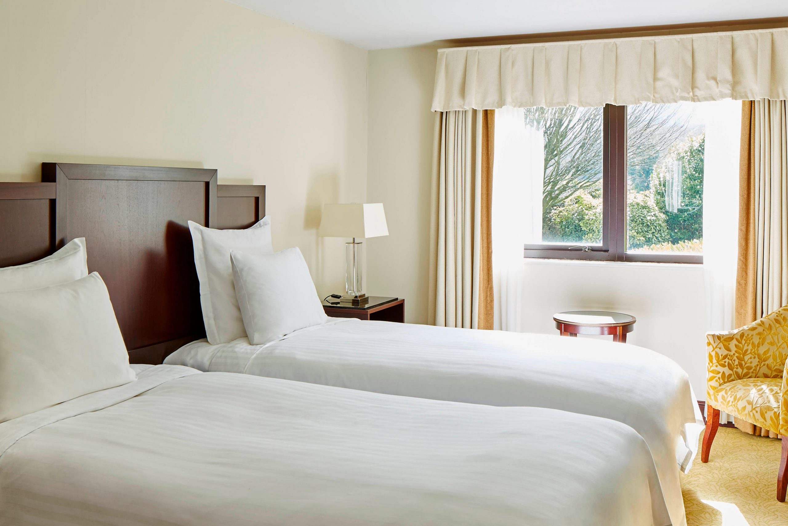 A deluxe rwin bedroom at St Pierre Marriott Hotel and Country Club, Chepstow, England