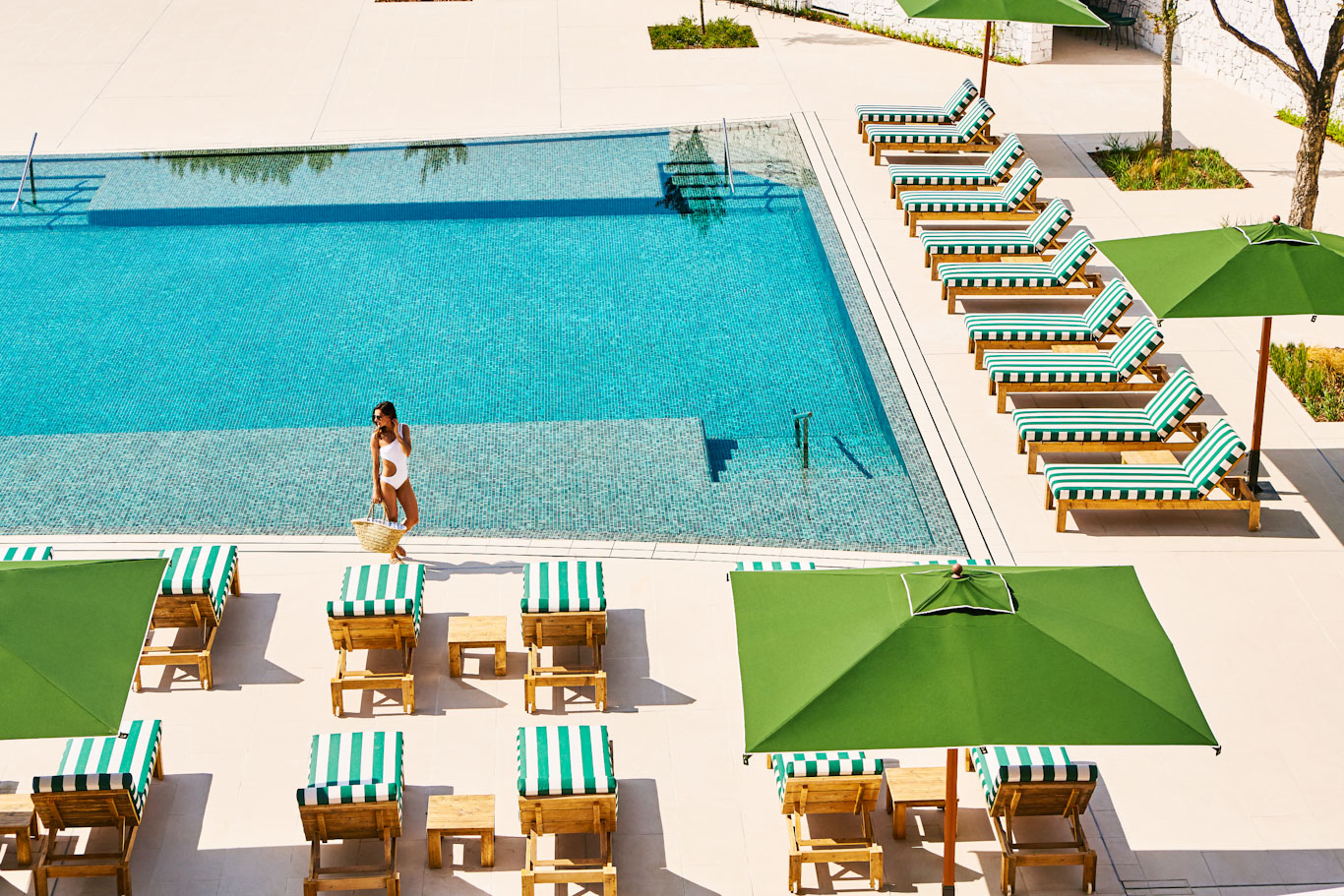 The large swimming pool at Hotel Camiral PGA Catalunya Golf Resort, Costa Brava, Spain, is surrounded by comfortable sun loungers
