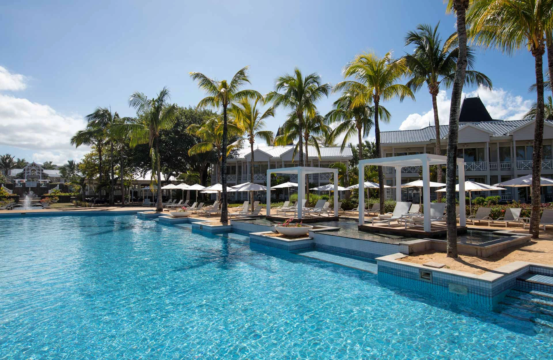 Pool view at Heritage Le Telfair Golf and Wellness Resort, Mauritius. Golf Planet Holidays.